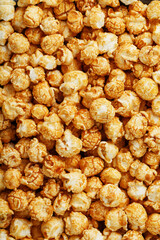 Caramel popcorn close-up as a background, full-screen texture.