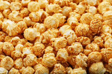 Popcorn in caramel glaze close-up as a background.