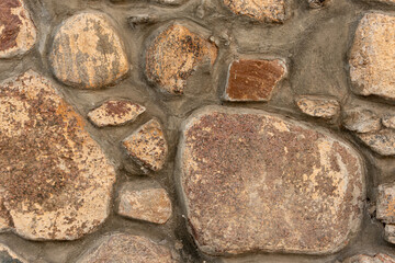 Cobblestone masonry, close-up stone wall, stone background, cobblestone pattern
