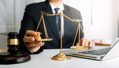 Business and lawyers discussing contract papers with brass scale on desk in office. Law, legal services, advice, justice and law concept  picture with film grain effect