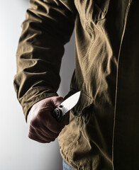 Man holding a knife in a threatening stance