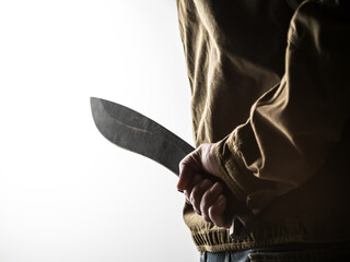 Man holding a machete behind his back