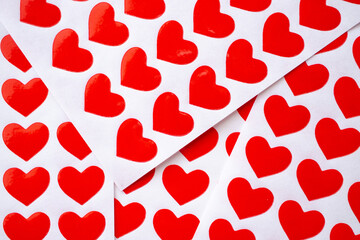 Fototapeta na wymiar Close up red heart sticker on white paper