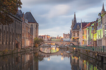 The beautiful historic old town of Ghent, Belgium along the Leie Canal at dusk.