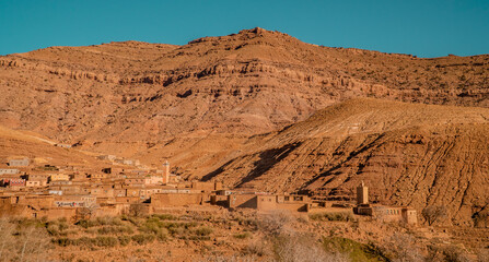 Panoramic view of a Berber village with a mosque and desert landscapes in the Atlas Mountains in Morocco