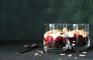 Dessert black forest with cherries in a glass on a dark green background. Traditional German...