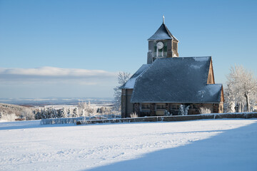 little village with a church in the winter
