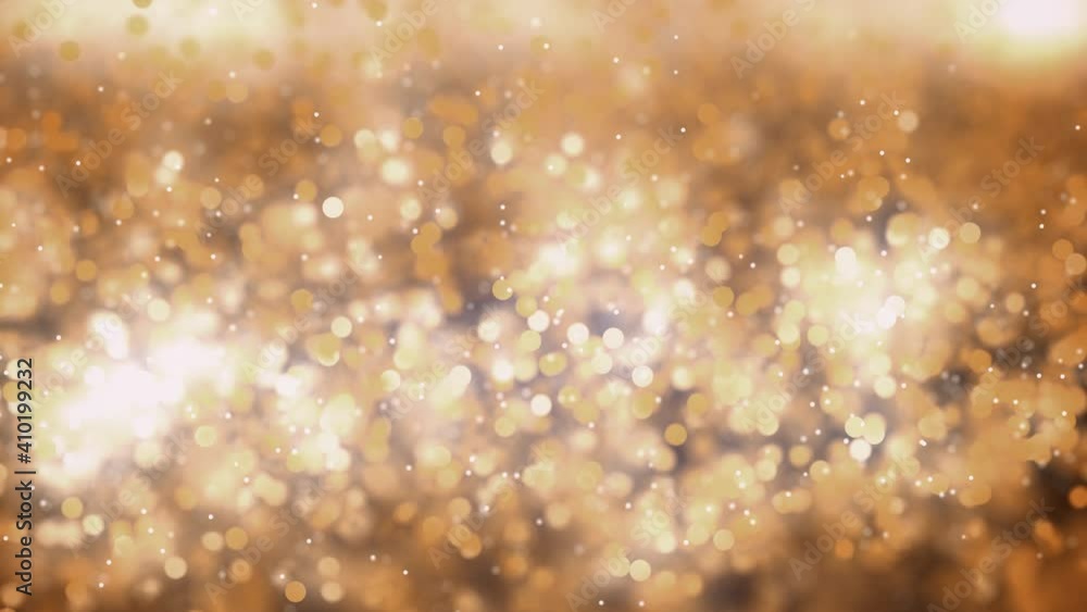 Poster slow motion animation of golden dust with extremely shallow depth of field.