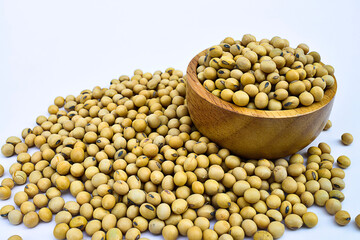 Soybeans or soya bean in wooden bowl and 
Pile of Soybeans on white background.
