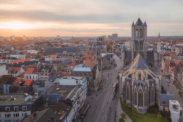 Aerial view of Saint Nicholas' Church and the beautiful historic old town of Gent, Belgium in golden evening light.