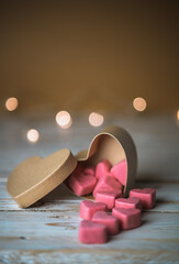 Valentines day pink hearts on white table with beige brown background