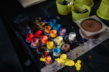 Close-up of tattoo pigment of different colors in boxes into needles