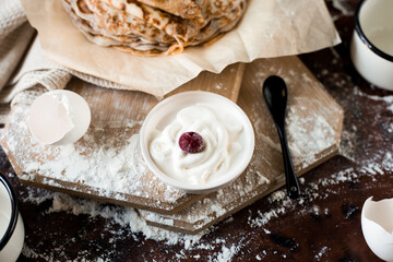 pancakes with sour cream on the table. Flat lay top-down