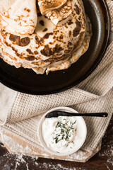 Shrovetide or crepes week. preparation of pancakes in a pan. Flat lay top-down