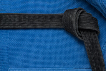 The view from the top. Kimono for judo classes and a black belt. The kimono is blue. Background,...