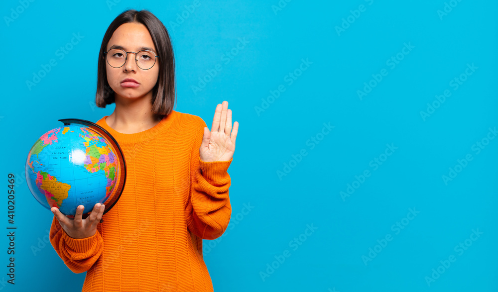 Canvas Prints young hispanic woman looking serious, stern, displeased and angry showing open palm making stop gesture