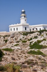 Fototapeta na wymiar Lighthouse with blue sky in Menorca