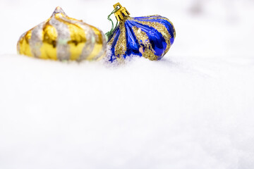 Bright blue and gold vintage Christmas toys on the snow. Close-up. Christmas and New Year