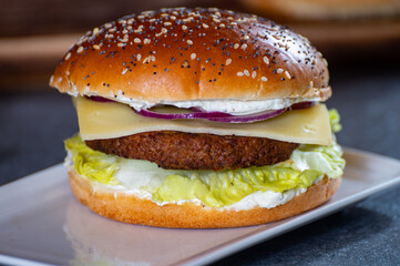 Lunch or dinner with tasty vegetarian hamburgers made from plant based grilled burgers, fresh bakes buns and organic vegetables