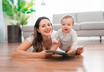 a happy mother with baby reading book