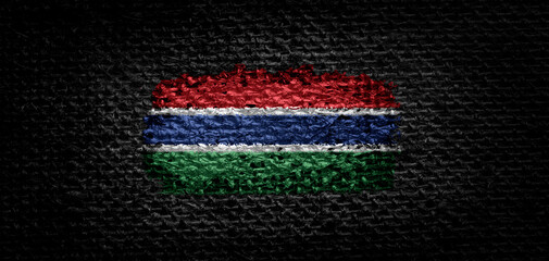 National flag of the Gambia on dark fabric