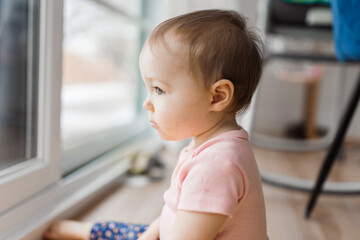 cute and Adorable girl look through window outside