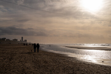 Winter walking on wide sandy beach of North sea near Zandvoort in Netherlands