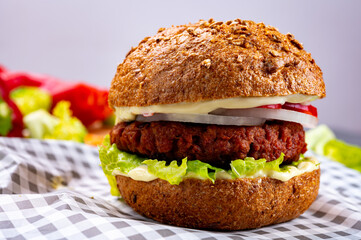 Tasty hamburger made with vegetarian plant based imitation minced meat burger and fresh vegetables