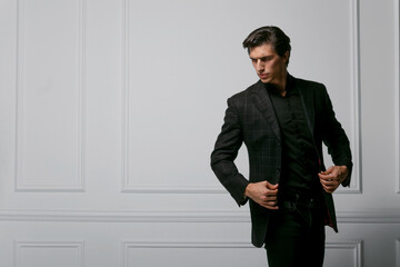 Obraz na płótnie Canvas Business man wear black suit portrait against a dark background. Closeup portrait of a handsome man. Horizontal view.