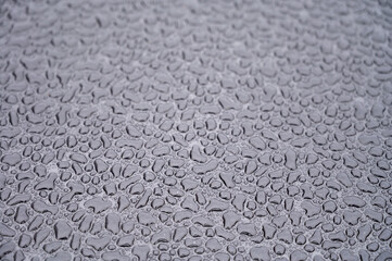 Textured background with rain waterdrops on glass