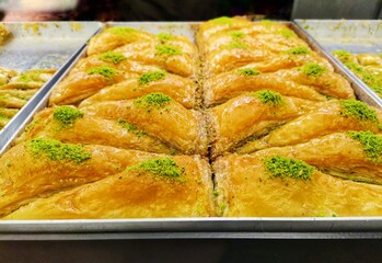 Baklava with pine nuts.  Turkish dessert baklava.  Sale of sweets at the bakery counter.  Triangular shaped diamond.