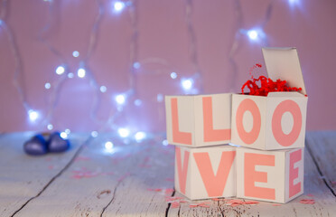 Boxes with love on the background of lights, pink love. Candy and gifts to your loved ones.