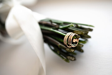 Elegant wedding rings on a flower composition closeup