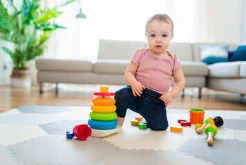 Cute toddler girl playing in the living room
