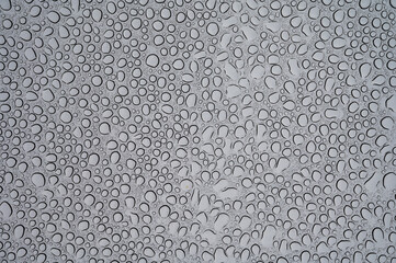 Textured background with rain waterdrops on glass