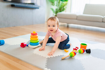 Cute toddler girl playing in the living room