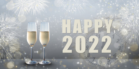 New Year celebration: Glasses of champagne and Happy 2022 text. Fireworks and clock in the background.