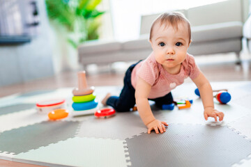 Cute toddler girl playing in the living room