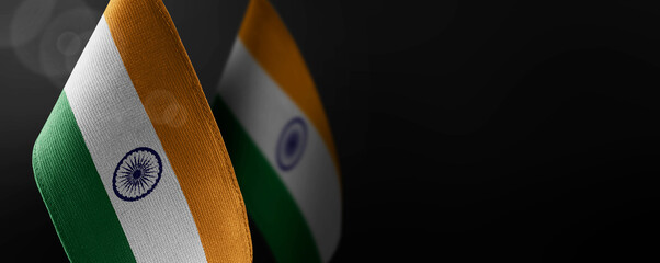 Small national flags of the India on a dark background