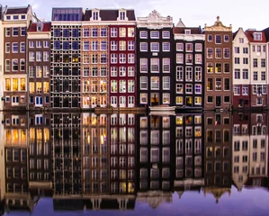 Fotobehang amsterdam houses on a canal with reflection © manuelakanolo