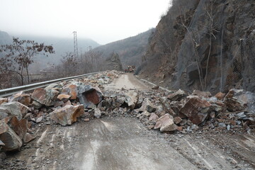 Elisseina, Bulgaria - February 2, 2021: Heavy chain and wheeled equipment clears the highway after a rock collapse near Elisseina station, Bulgaria