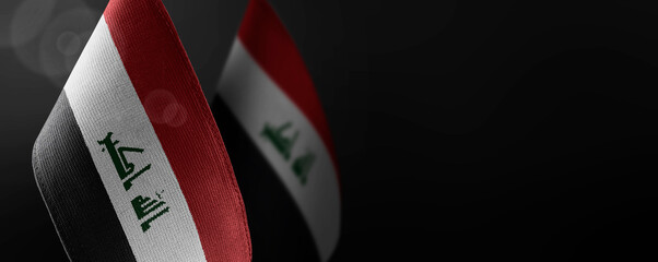 Small national flags of the Iraq on a dark background © butenkow