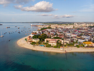 Zanzibar Aerial Shot of Stone Town Beach with Traditional Dhow Fisherman Boats in the Ocean at Sunset Time