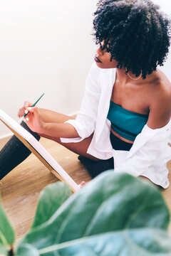 Beautiful Black Woman Artist Painting On Canvas At Home