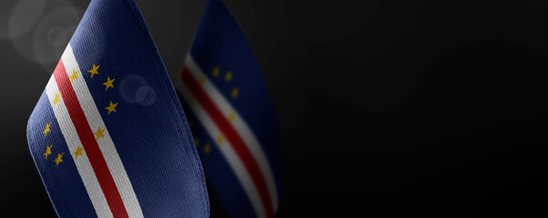 Small national flags of the Cape Verde on a dark background