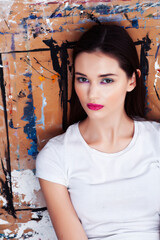 young brunette woman with fashion makeup on painted background, lifestyle people concept