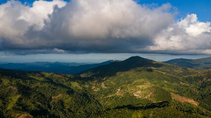 big clouds above the green mountains 