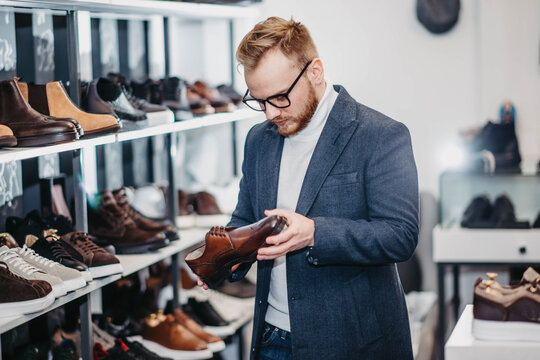 man in a shoe store buys shoes