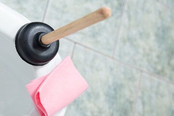 Clean clogg in toilet bowl. Using suction cup to clean up the toilet.