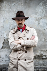 Portrait of a detective with folded arms in a ghetto